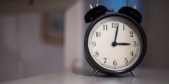 black and white round analogue alarm clock